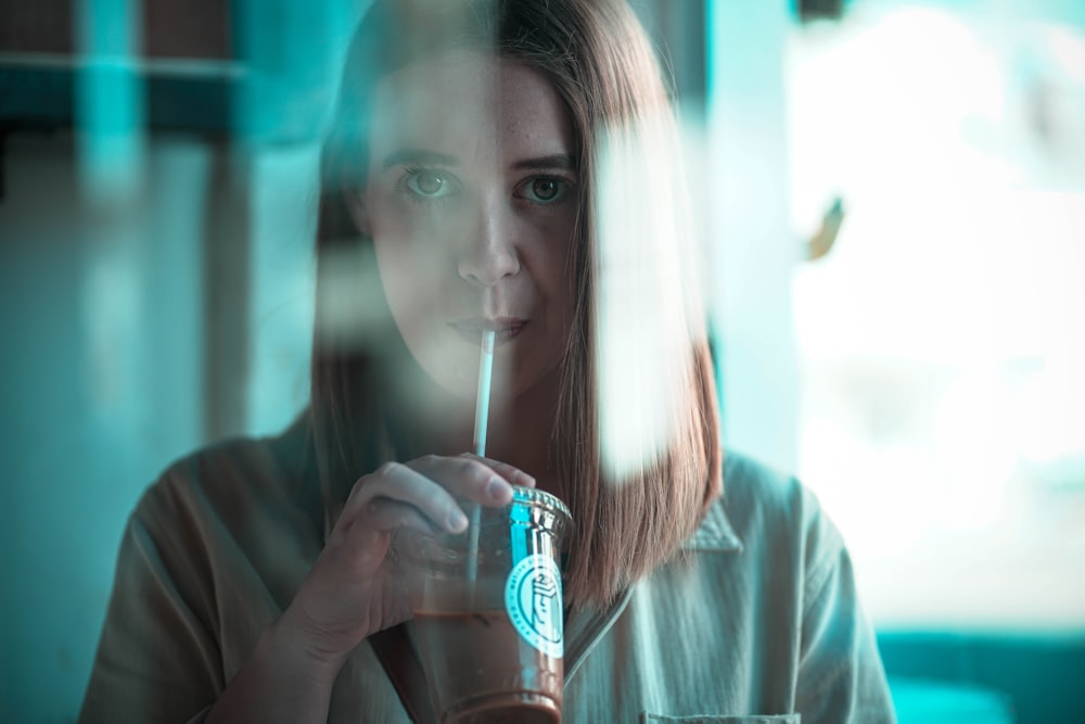 a woman holding a straw in her hand