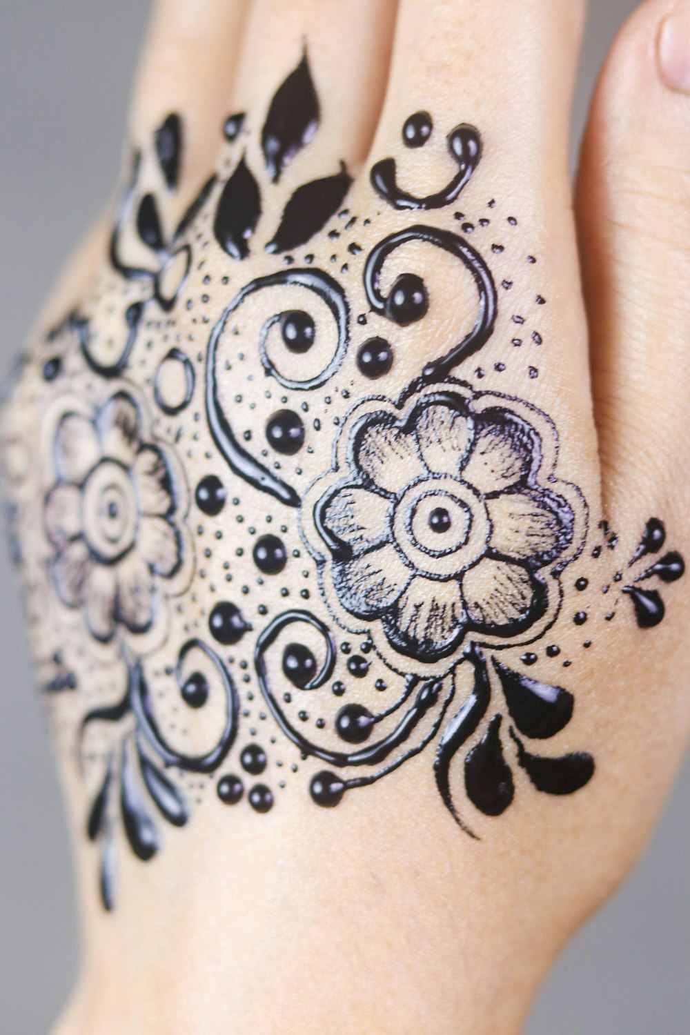 black floral hand tattoo art