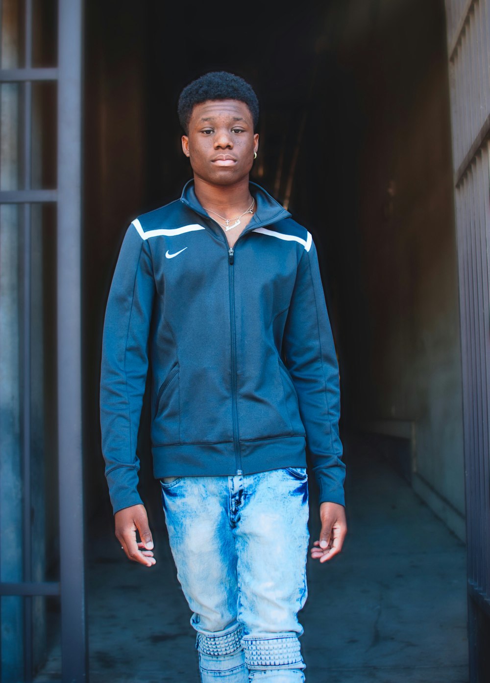 man about to walk wearing black Nike jacket