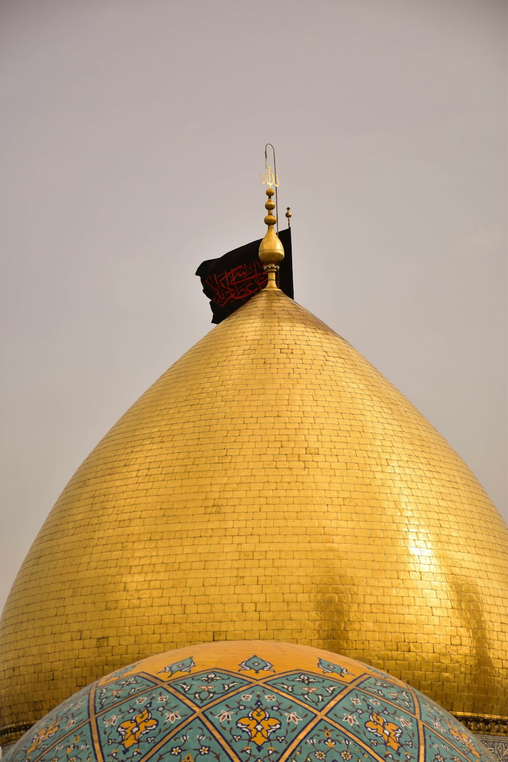 a gold dome with a flag on top of it