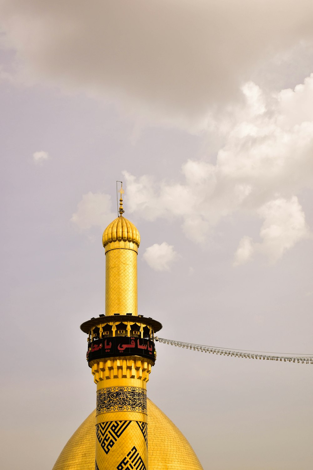 yellow and black concrete minaret tower