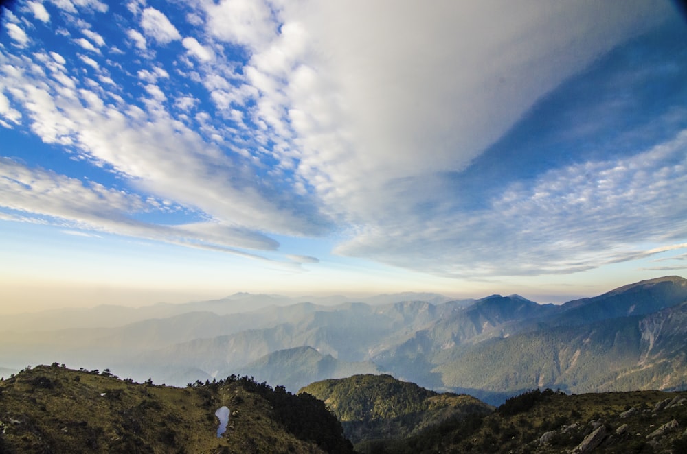 grass covered mountains during day