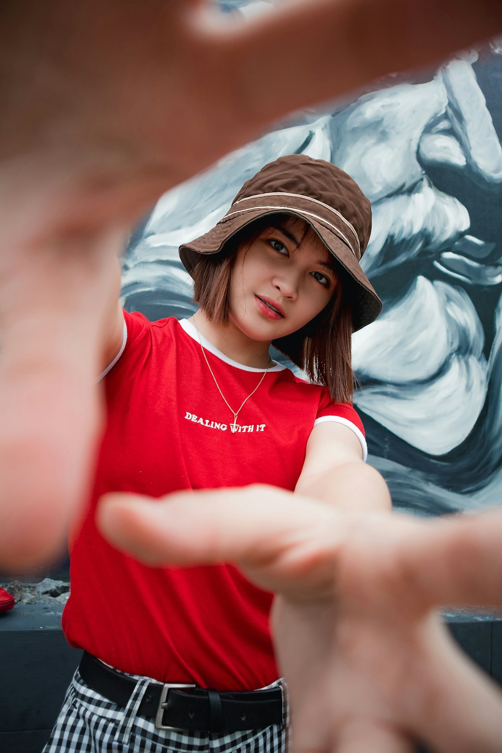 woman stands near wall