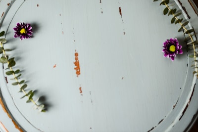 A rustic wooden tray with hand-painted floral designs.