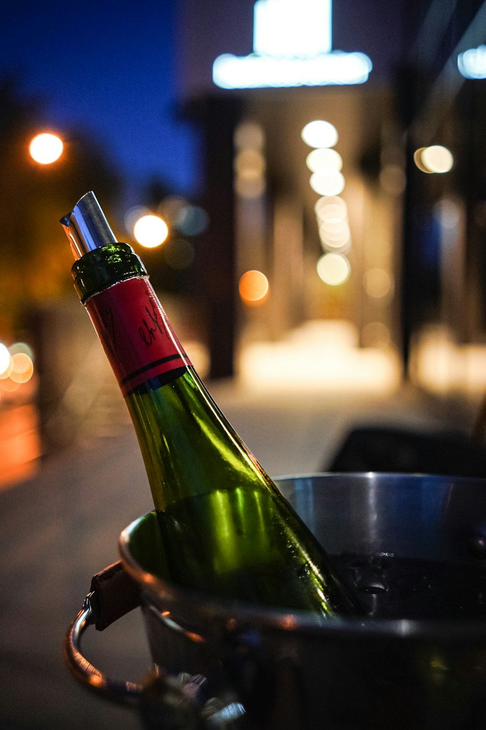 selective focus photography of bottle in bucket