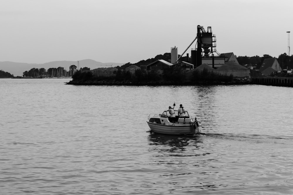 people riding ski boat near buildings