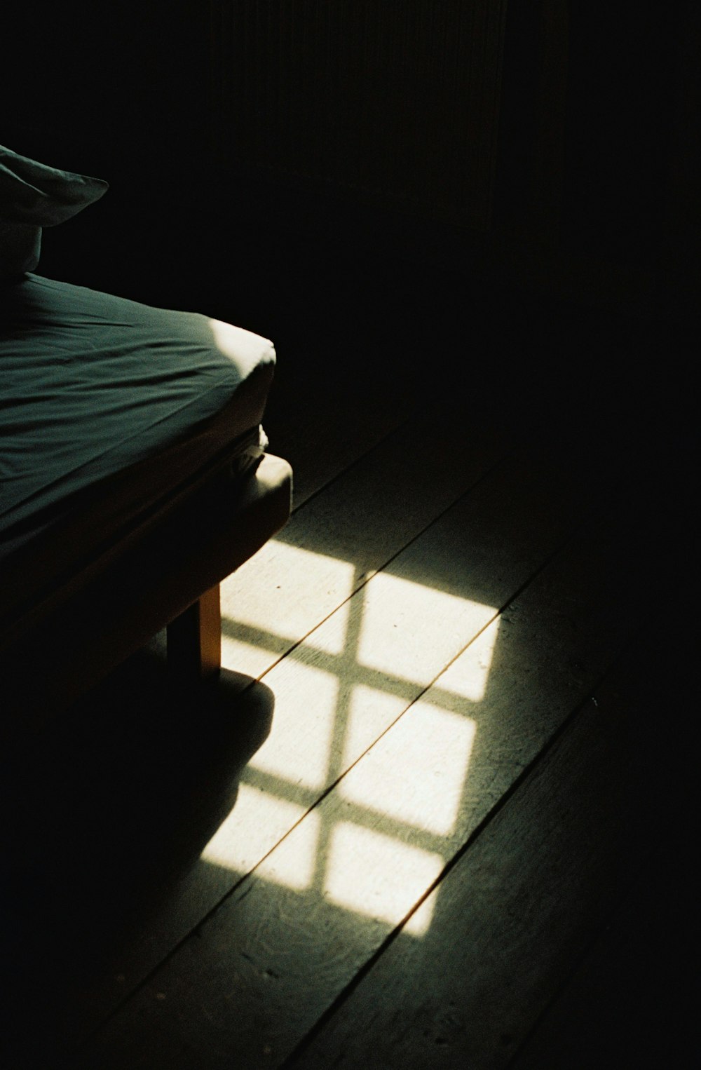 reflection of window on brown wooden floor
