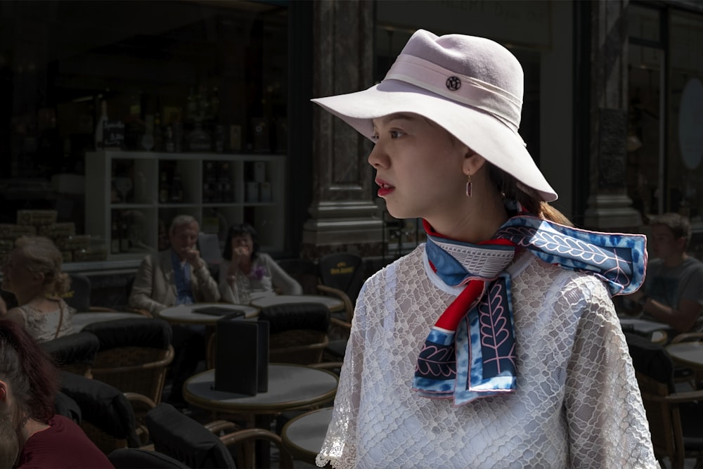 woman wearing white lace top and hat