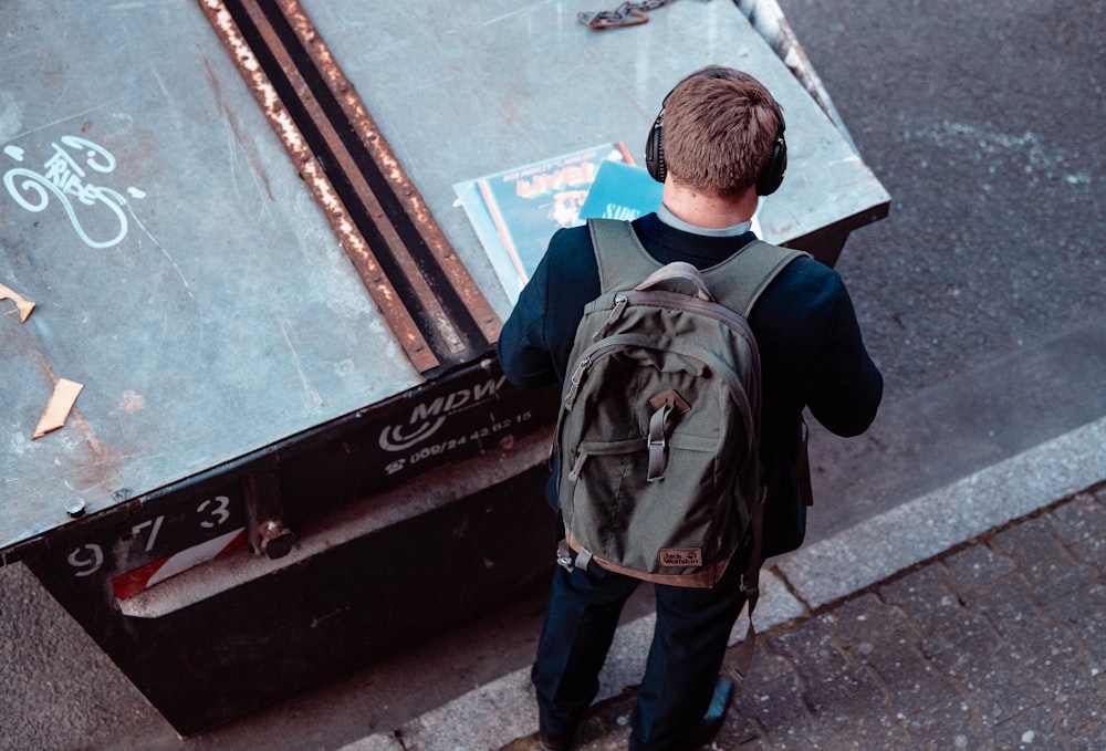 man standing with black backpack