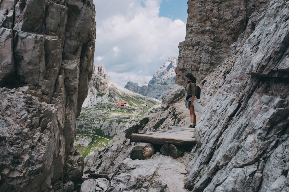 woman standing beside rocks