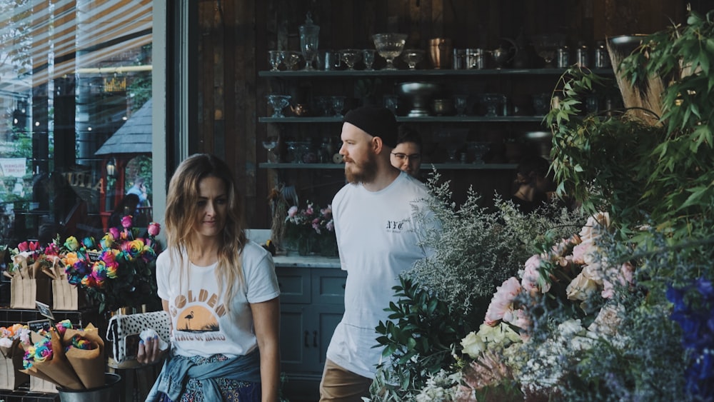 man wearing white shirt behind woman