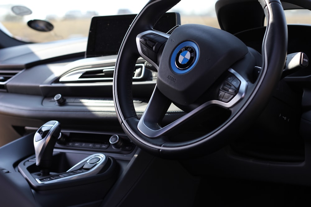 the interior of a car with a steering wheel and dashboard