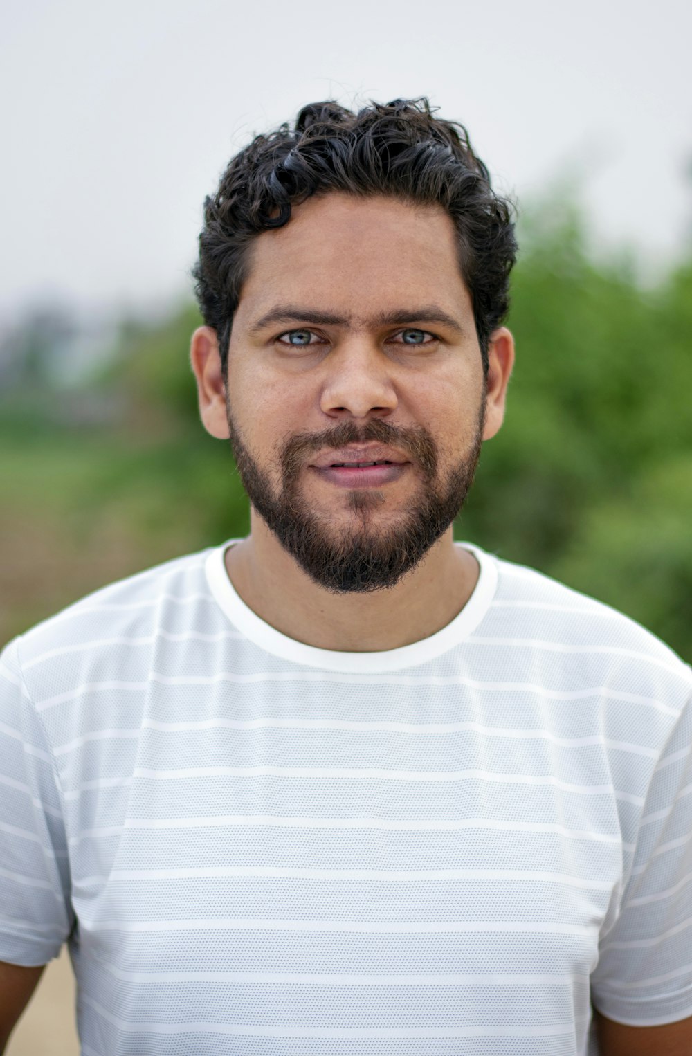 a man with a beard is posing for a picture