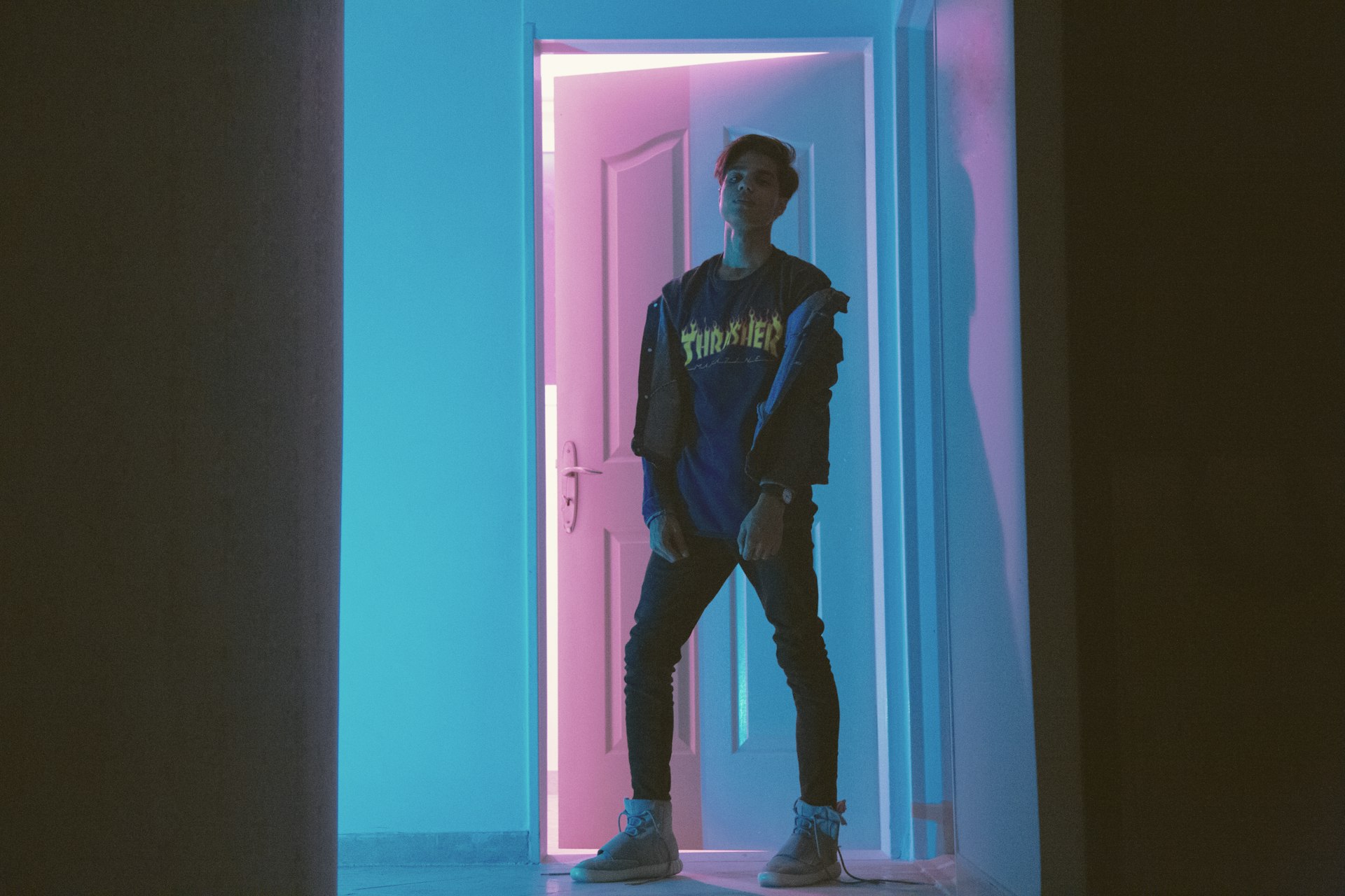 man standing outside a semi-opened door
