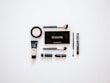 Various cosmetic products like lipsticks, creams, and brushes arranged on a clean white surface.