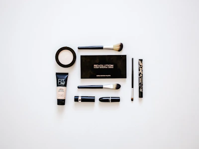 Elegant makeup items arranged neatly on a clean, modern vanity.