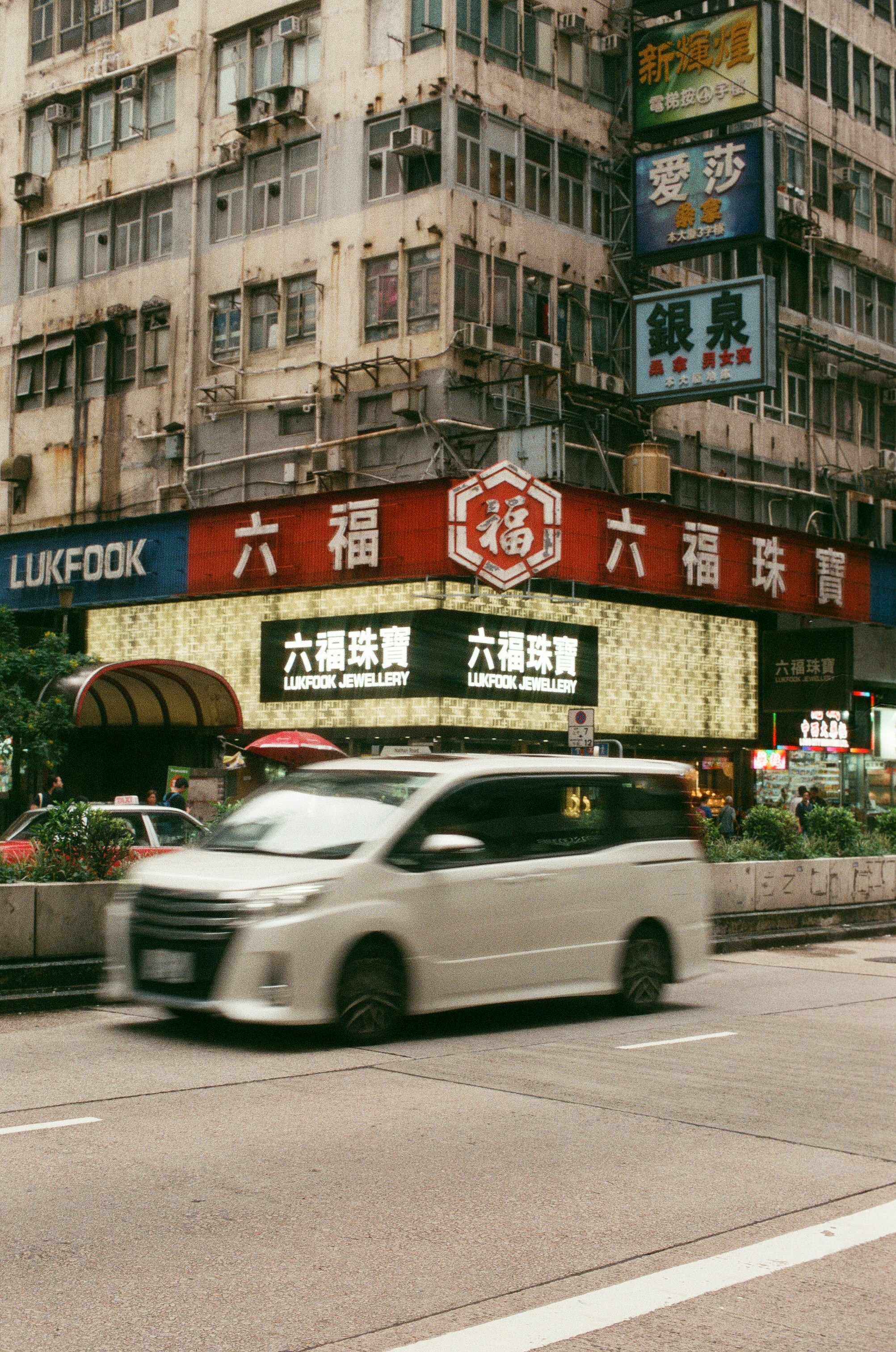 white van on road viewing high-rise buildings