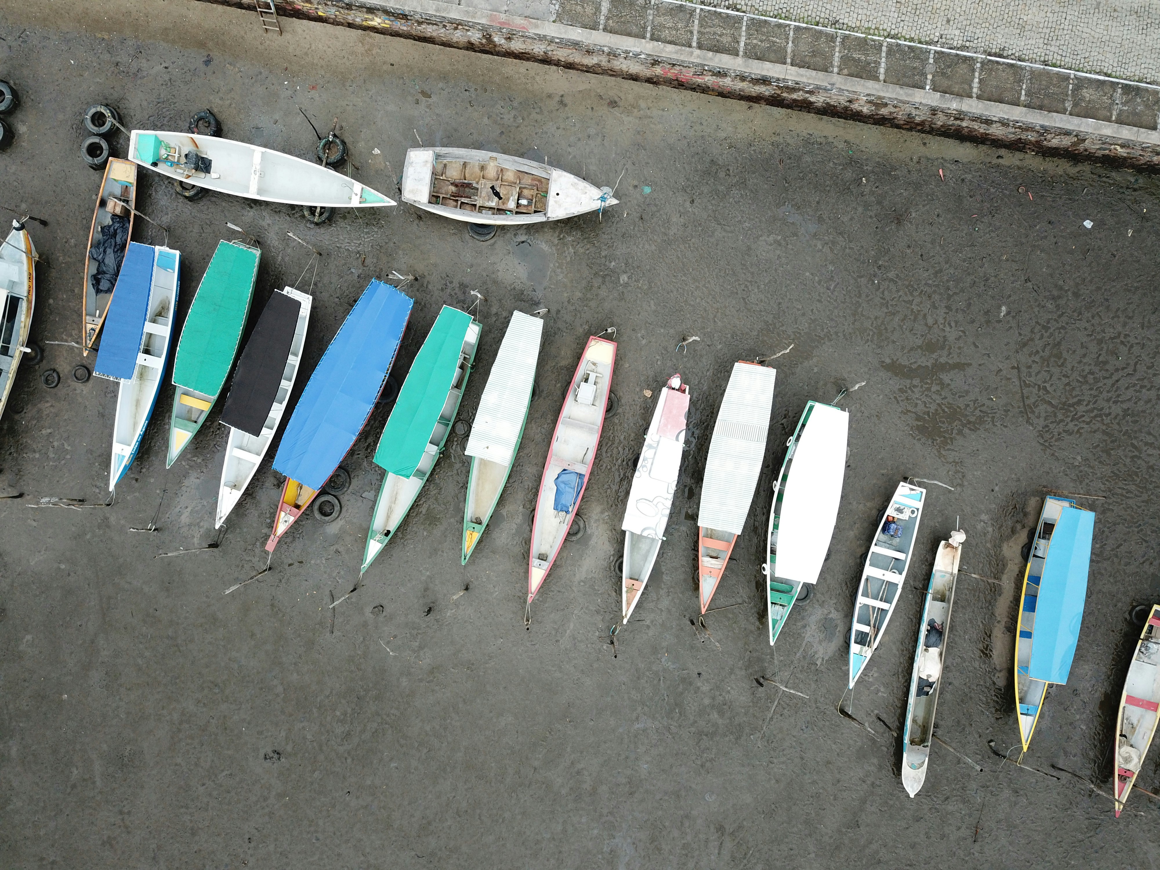 Aerial photography of canoes on gray sand