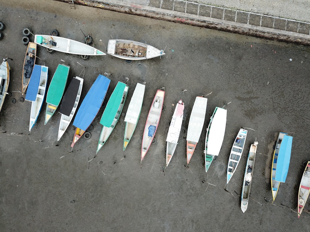 aerial photography of canoes on gray sand