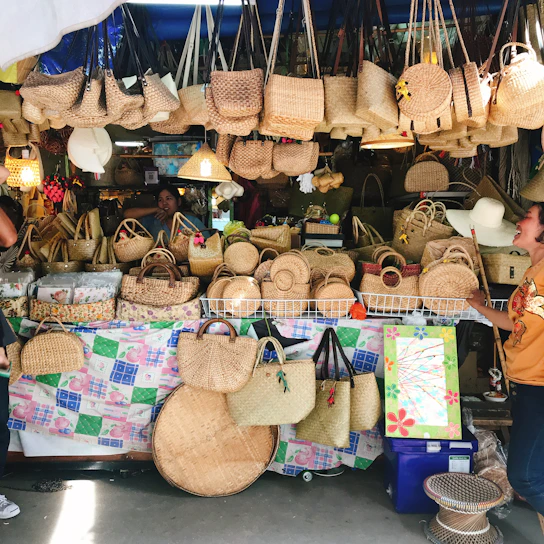 A vibrant market stall displaying handmade eco-friendly bags made from natural fibers.