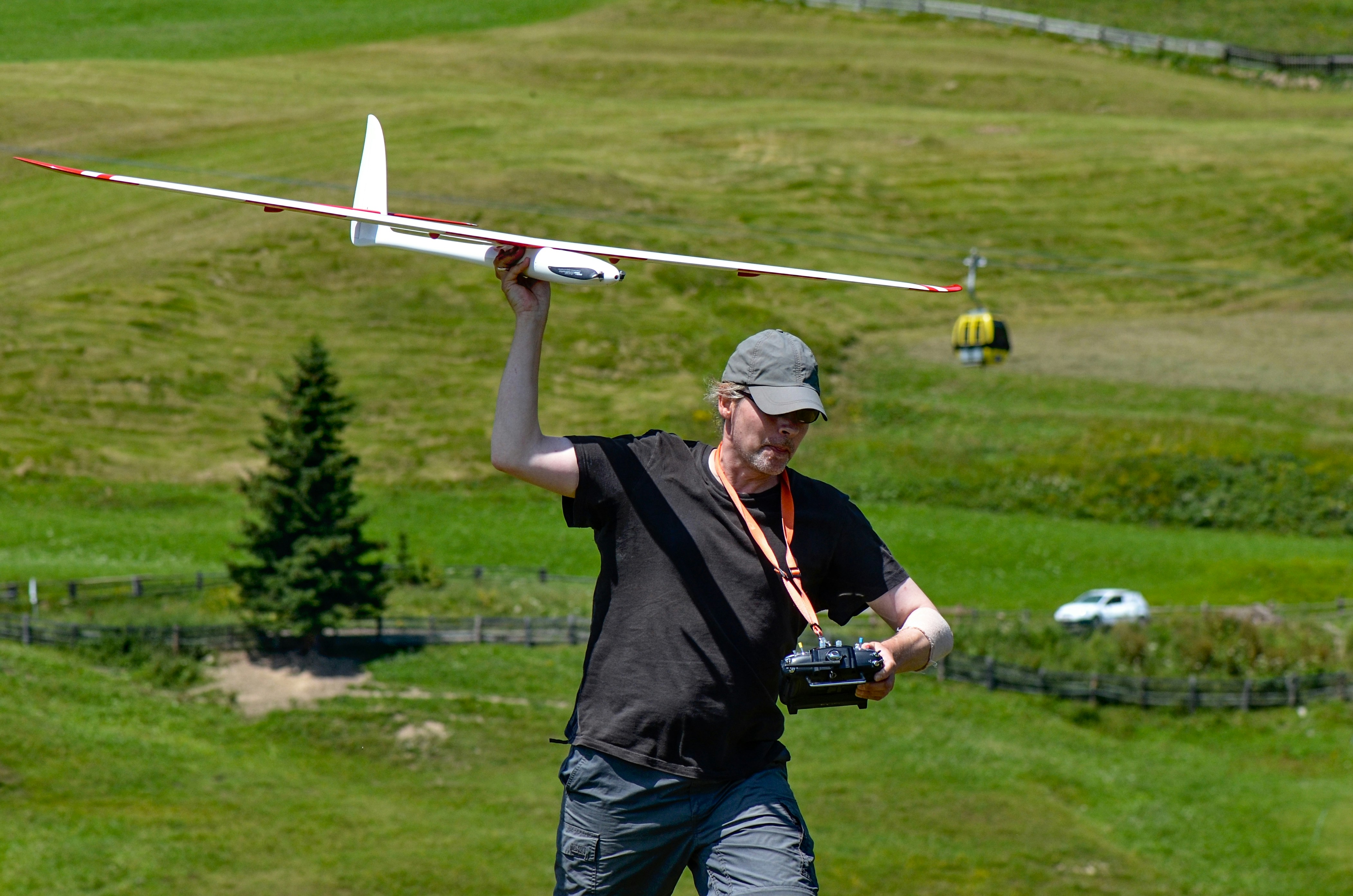 man walking and holding RC plane toy