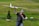 An enthusiastic hobbyist displaying their RC aircraft in a park.