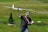 An enthusiastic hobbyist displaying their RC aircraft in a park.