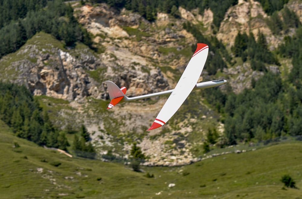 Rot-weißes Spielzeugflugzeug am Himmel