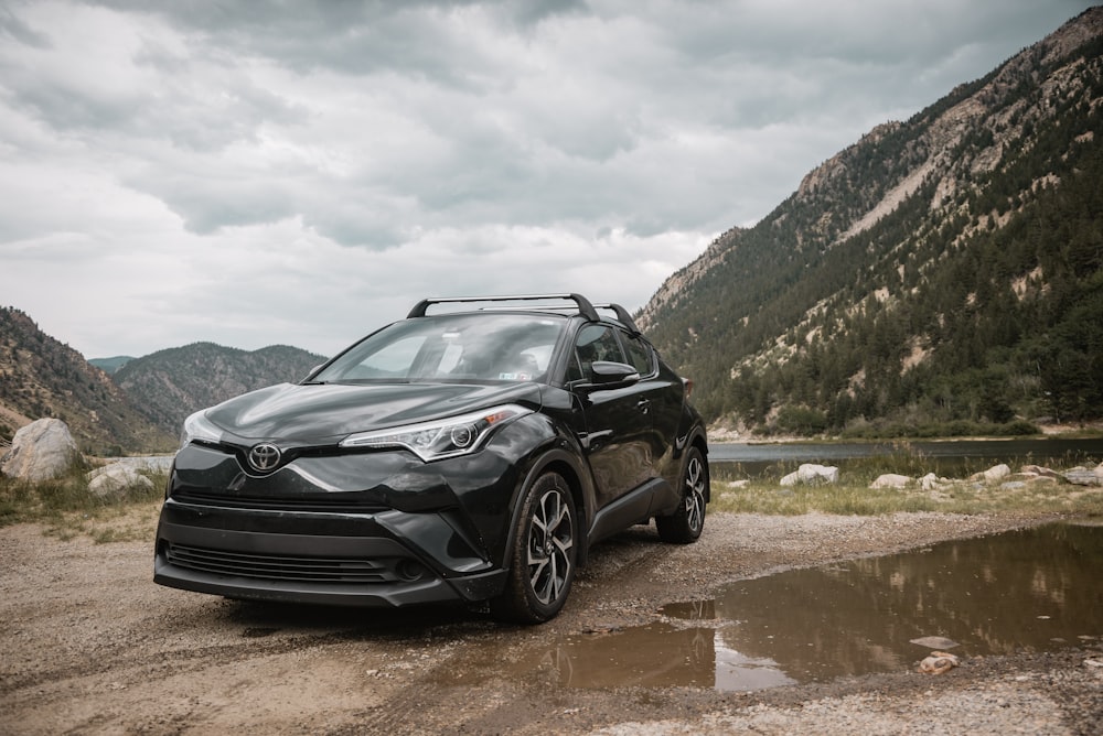 black Toyota vehicle at the bottom of the mountain