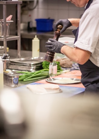 man putting herb on food