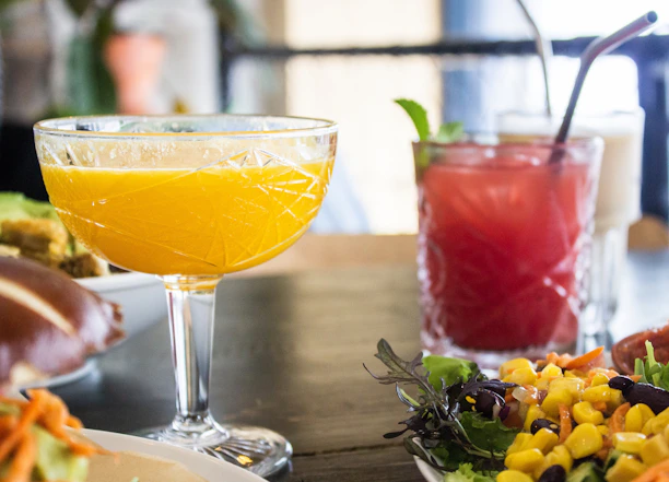 Close-up of a beautifully arranged table with colorful drinks and appetizers.