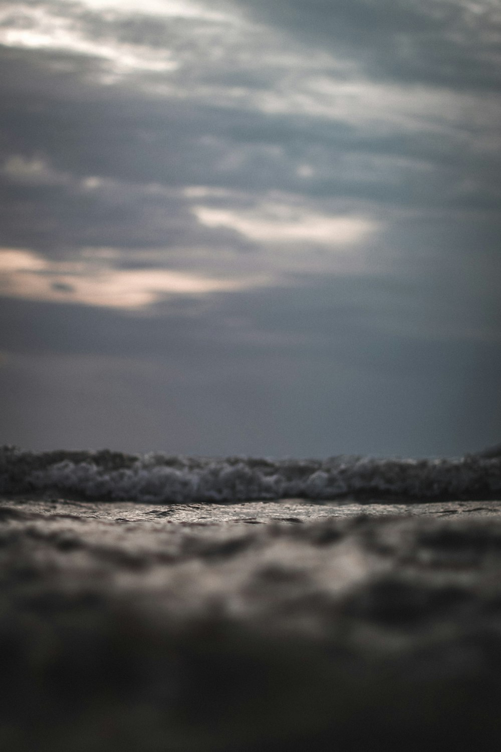 a person walking on the beach with a surfboard