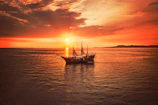 brown boat on calm water