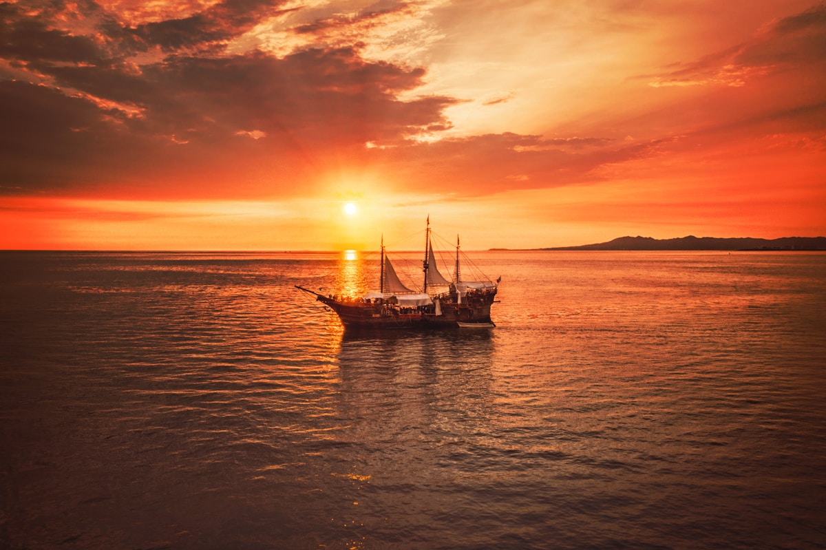 A boat on calm water at sunset