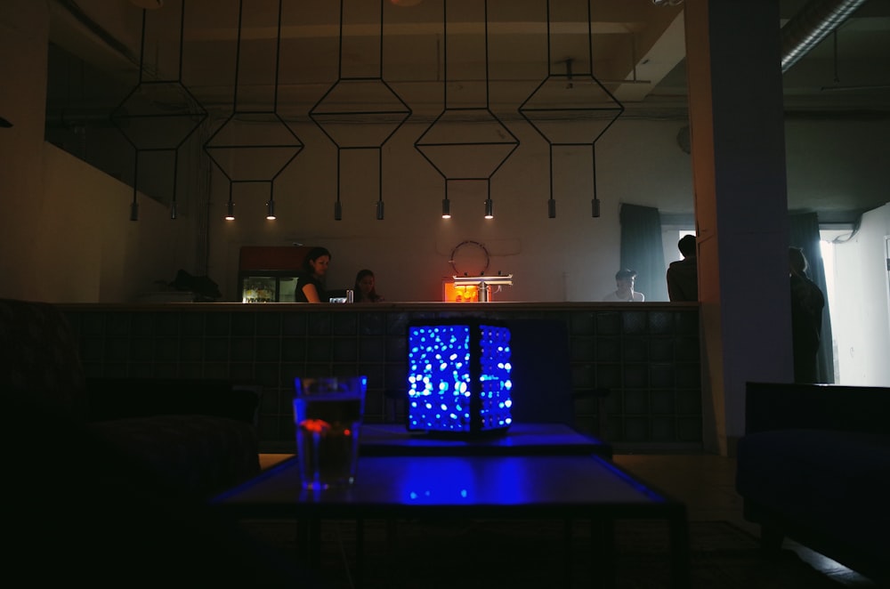 a table with a blue light in the middle of it