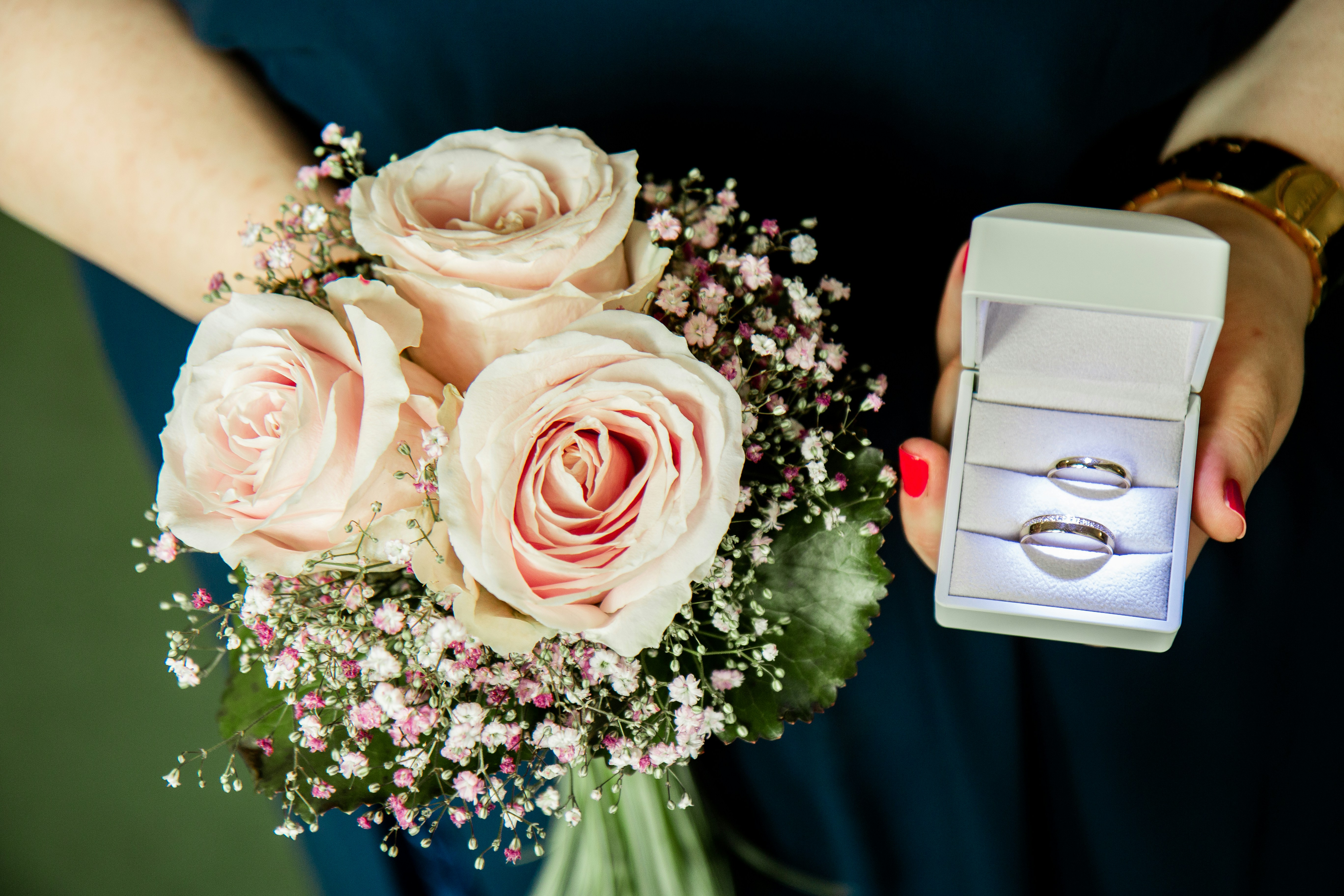 Wedding rings flowers, Wedding planner notebook, Couple holding hands, ilustrasi artikel Stress-Free Wedding Budgeting: Your Ultimate Guide to a Joyful Day 3