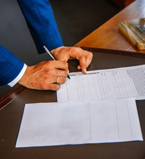 person writing on white form paper