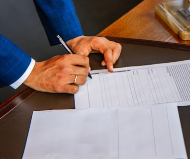 person writing on white form paper