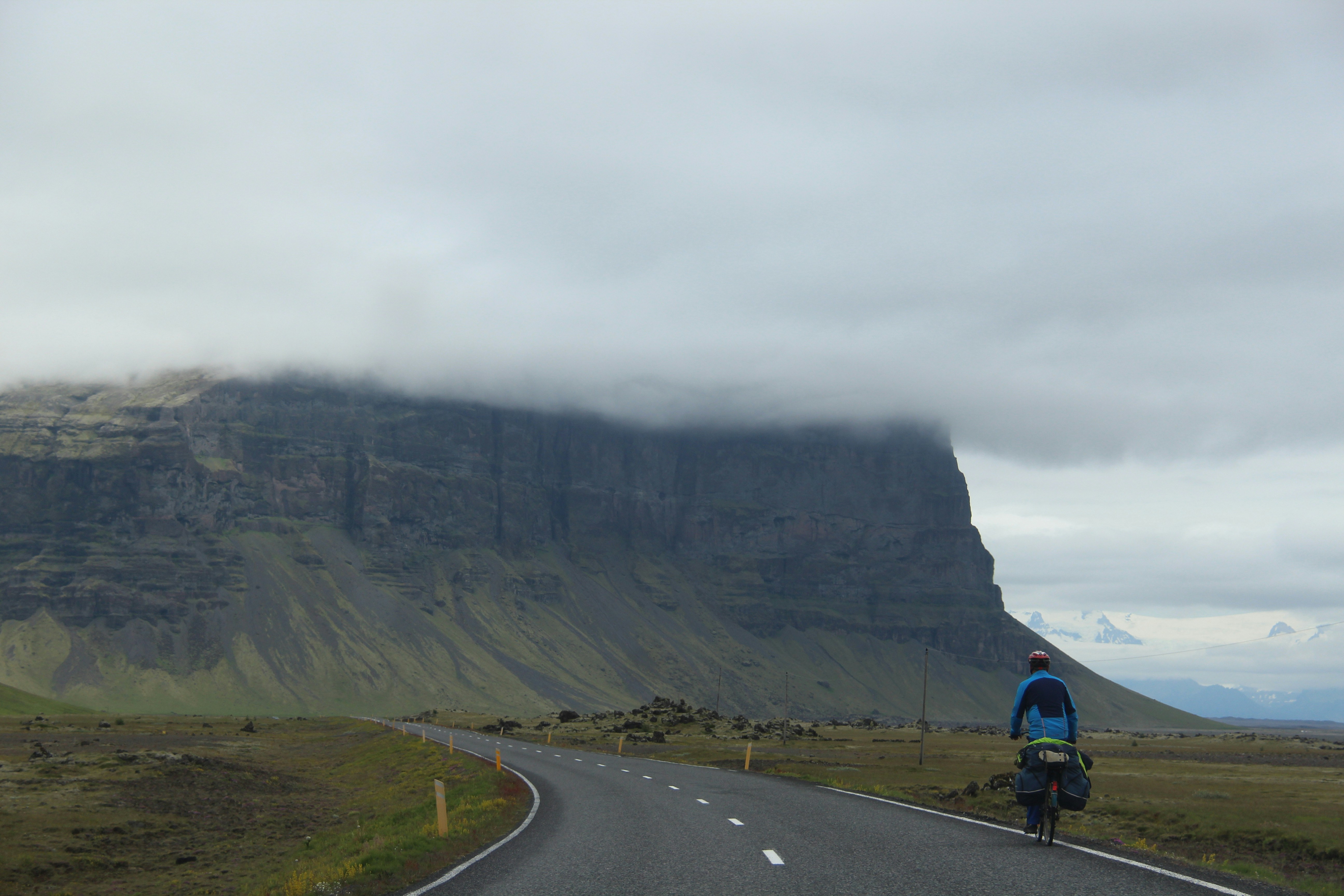 man riding bike on empty road