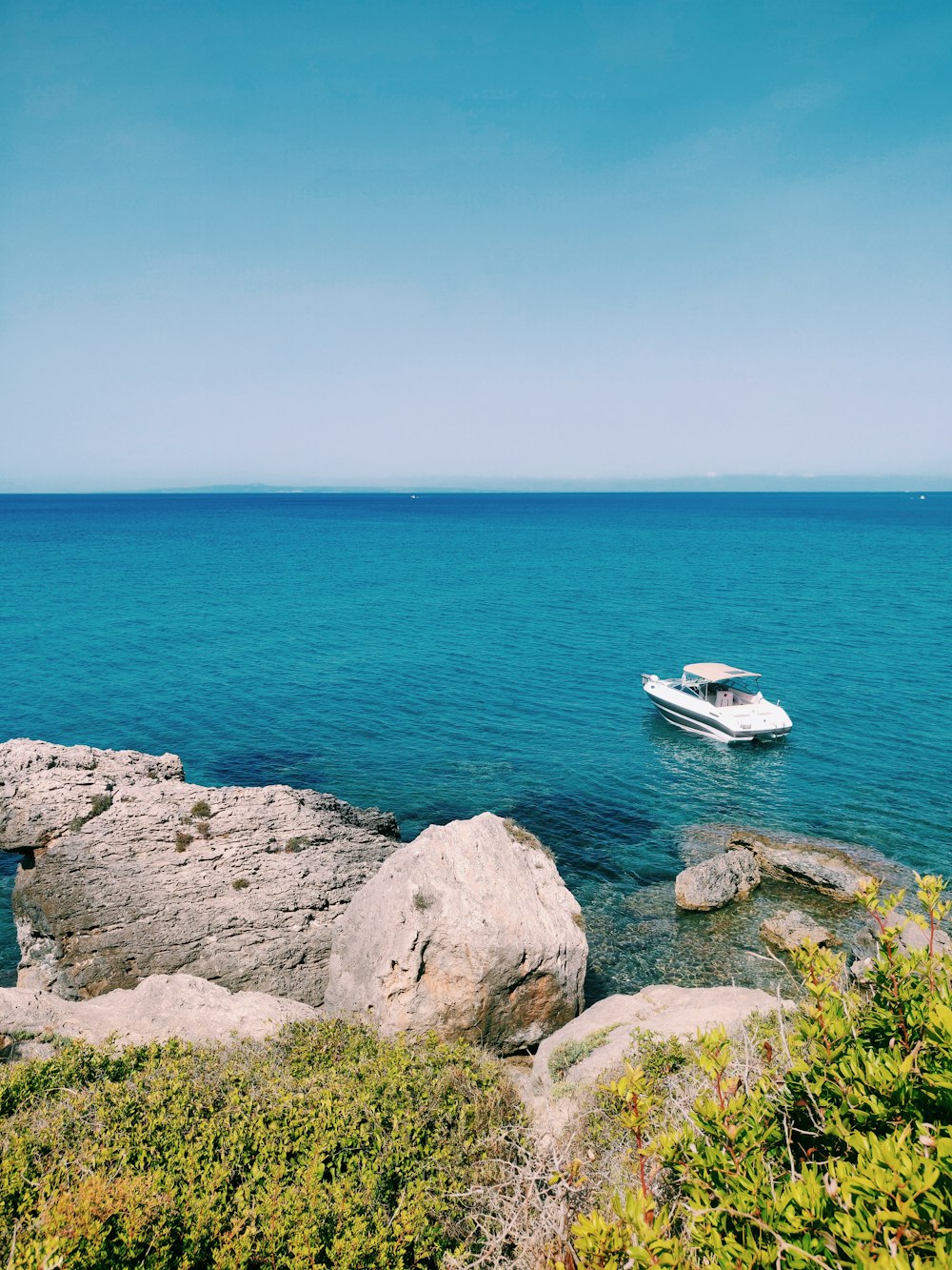 yacht on body of water near seacliff