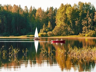 two person on red sailboat