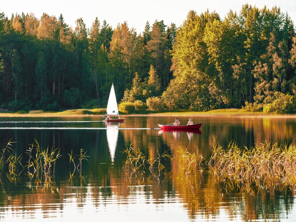 two person on red sailboat