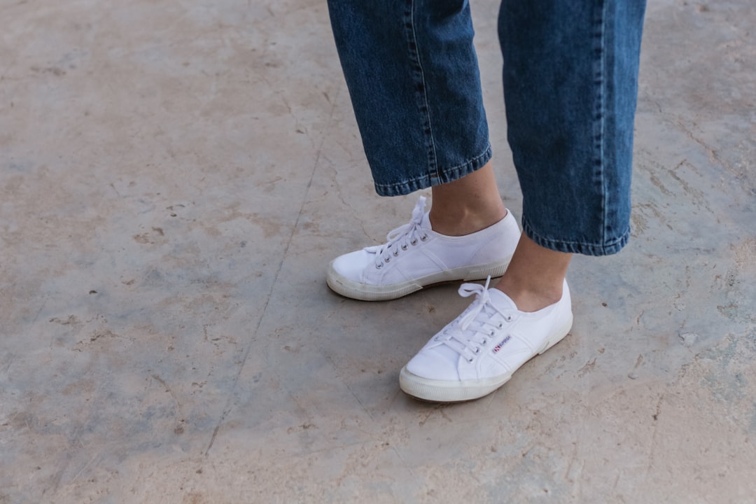 person in blue denim jeans wearing white sneakers photo – Free Apparel ...