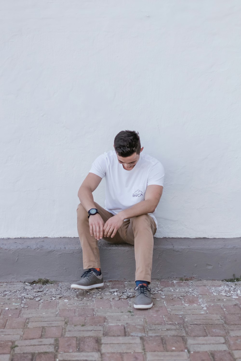 man sitting on concrete ground