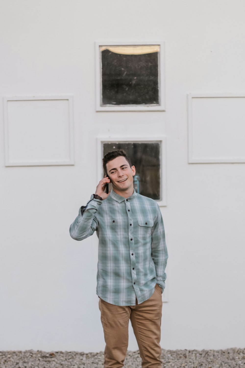 man standing beside building