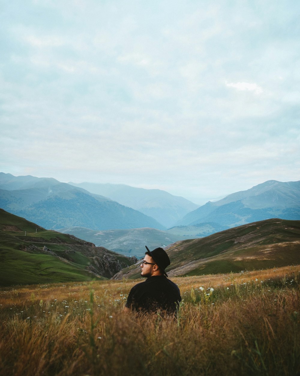 man standing on plant field during daytime