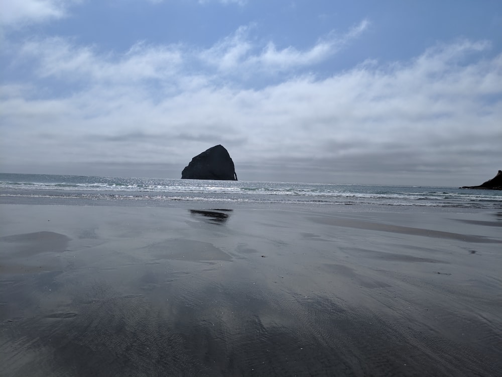 black coastal stack during daytime