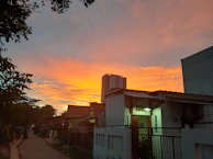 A serene sunset over a thriving neighborhood, reflecting hope and long-term impact.