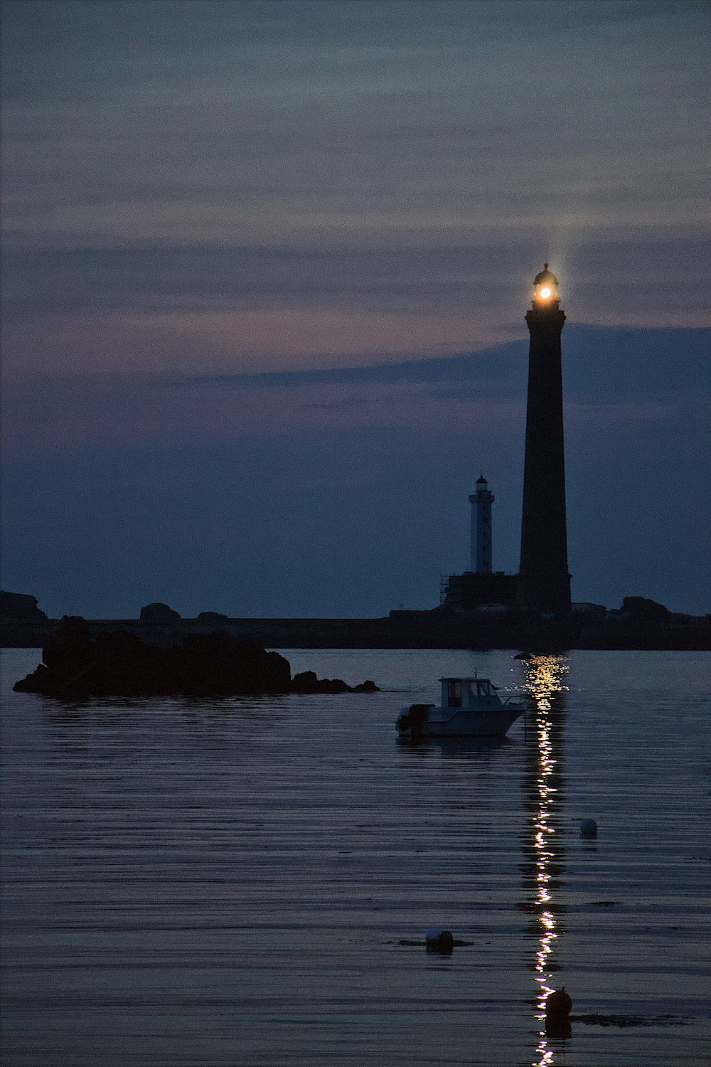 lighthouse by the sea at dusk