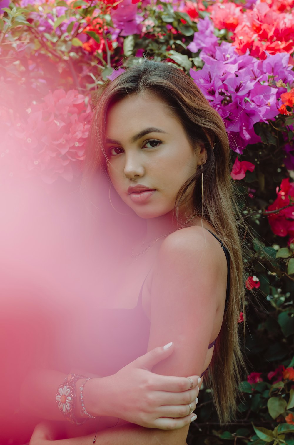 woman looking at her left in front of flowers